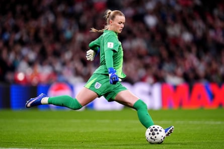 Hannah Hampton kicks a football.