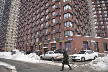 A citizen walks past the residential building in Moscow where the shooting took place