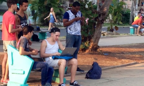 Teenagers using wifi at a park.