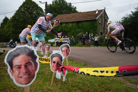 Luc van de Populiere poses for a picture with pictures of Belgium's Wout van Aert as Norway's Jonas Abrahamses.