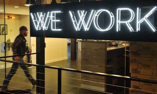 A man entering the doors of the WeWork co-operative co-working space in Washington