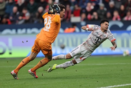 Luis Díaz falls under a challenge from Janis Blaswich, the Bayer Leverkusen goalkeeper