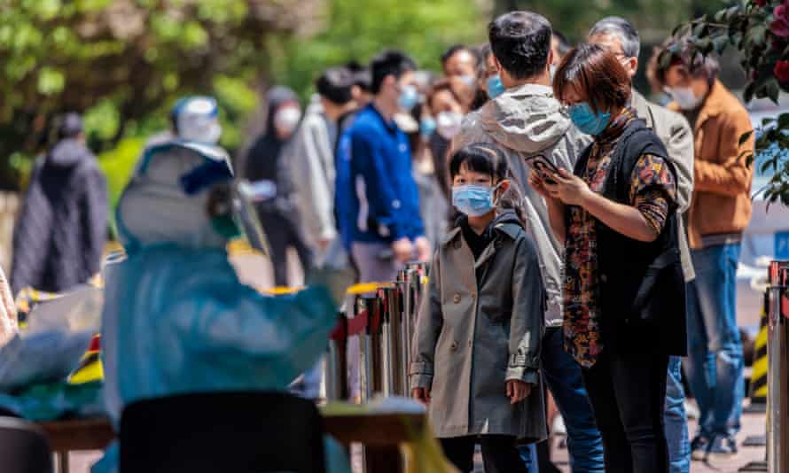 People line up for Covid-19 tests in a residential community under lockdown in Shanghai, China