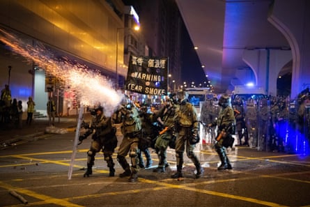 Riot police fire tear gas during a demonstration in 2019