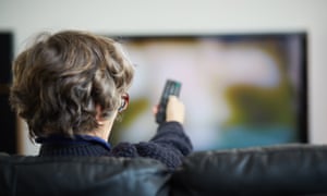 Woman points remote at TV