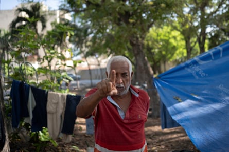 A man in a camp points his index finger