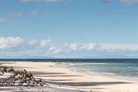 A white sandy beach on a sunny day in Scotland