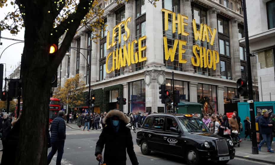 Christmas shoppers walk past the flagship Selfridges site in Oxford Street this month