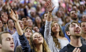 Liberty University students pray before a speech by Bernie Sanders.