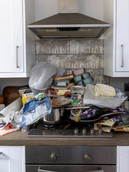 The top of an oven covered with empty ready meal packets.