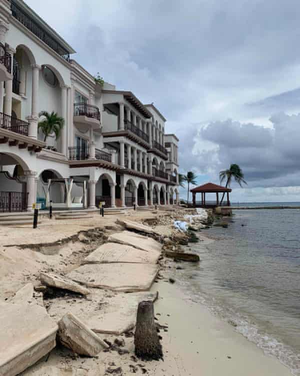 A crumbling terrace outside a new beachfront development with the sea only a few metres away