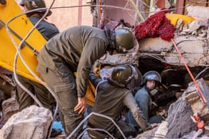 Rescue workers search for survivors in a collapsed house in Moulay Brahim.