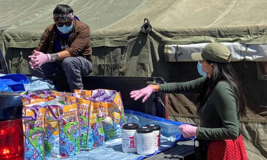Volunteers load supplies into a pickup truck at a farm, used as a base for aid to Navajo families quarantined in their homes due to coronavirus in Hogback, Shiprock, New Mexico, last month.