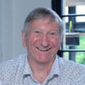 Smiling face of a grey-haired man