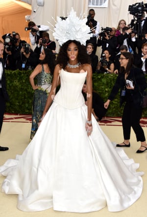 Model Winnie Harlow turned to Tommy Hilfiger for her strapless white gown and dramatic headpiece.