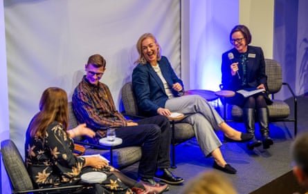 Four people seated chat and laugh