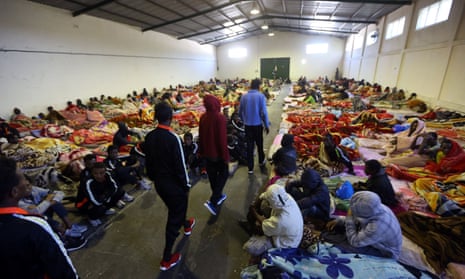 African migrants sitting in a shelter at the Tariq Al-Matar migrant detention centre on the outskirts of the Libyan capital, Tripoli.