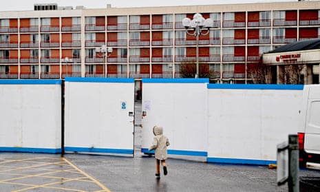 A child runs outside the gates of the Crowne Plaza hotel at Heathrow in 2021, which was housing asylum seekers. 