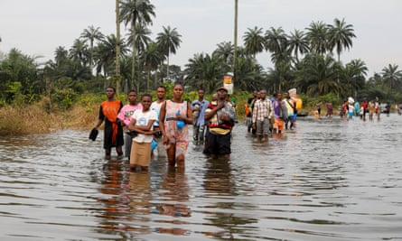People wade through flood water in Obagi community, Rivers state, Nigeria