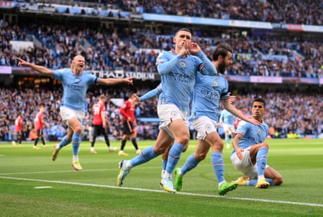 Phil Foden of Manchester City celebrates scoring the first goal against Manchester United at the Etihad Stadium.