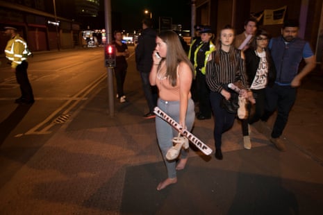 Concert goers react after fleeing the Manchester Arena