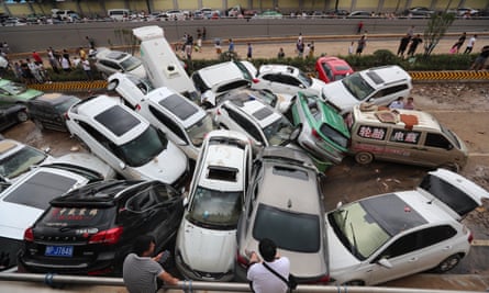 Torrential Rains Hit HenanZHENGZHOU, CHINA - JULY 22: Damaged cars sit on a muddy road at the entrance of an expressway tunnel on July 22, 2021 in Zhengzhou, Henan Province of China. Torrential rains hit Henan since July 16, causing floods in many parts of the province on Monday and Tuesday. (Photo by Bai Zhoufeng/VCG via Getty Images)