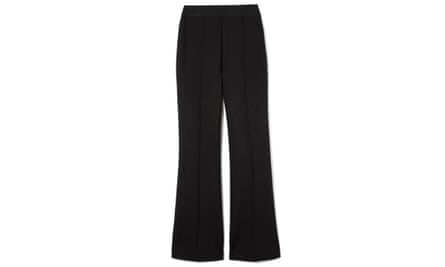 A pair of black kickflare trousers on a white background