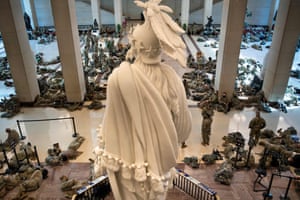 Members of the National Guard rest in the Capitol Visitors Center on Wednesday.