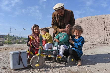 A health worker administers Polio vaccine to a child in the border region of Nangarhar, Afghanistan.