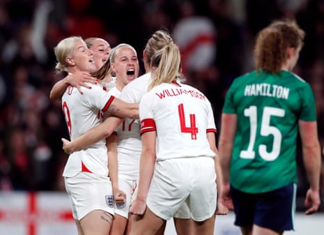 England’s Bethany Mead celebrates scoring their first goal with teammates.