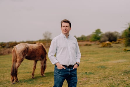 James Hartley-Binns, organiser of the New Forest Together campaign group, stands in front of a horse