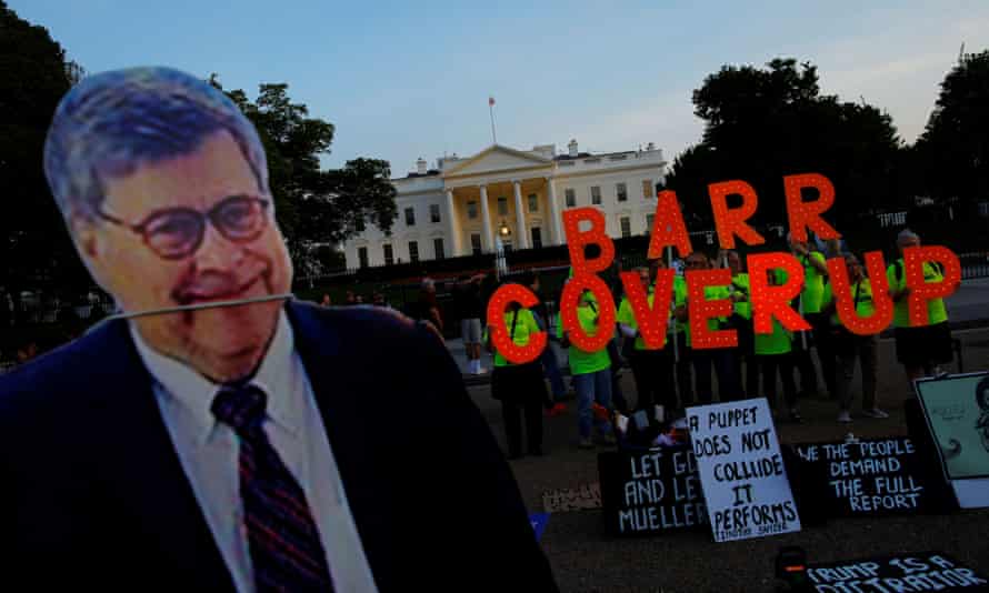A cardboard cutout of US attorney general William Barr is seen as protesters hold signs outside the White House.