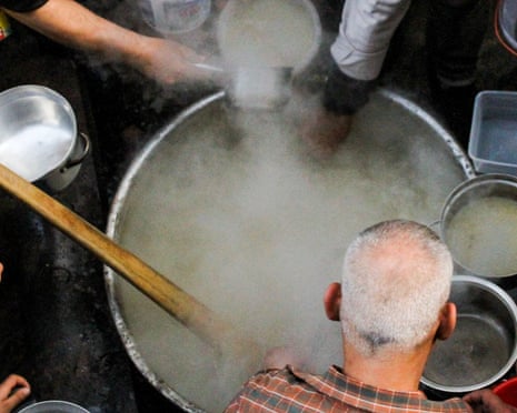 Soup in a large cauldron is distributed for free to vulnerable individuals and families in Gaza City in April 2022.