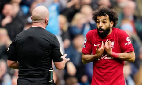 Liverpool's Mohamed Salah remonstrates with referee Simon Hooper after receiving a yellow card during the English Premier League soccer match between Manchester City and Liverpool.