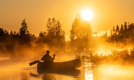 golden light on lake and canoe