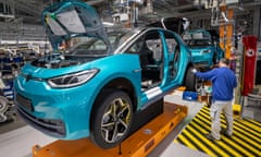 A Volkswagen employee works on an ID.3 car in the assembly line during the production of the electric car at Zwickau, Germany, in 2020.