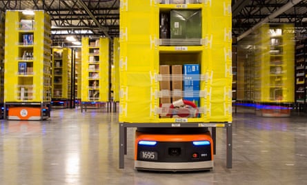 Robots move inventory at an Amazon fulfilment warehouse. Amazon installed more than 15,000 robots across 10 US warehouses, a move that promises to cut operating costs by one-fifth.
