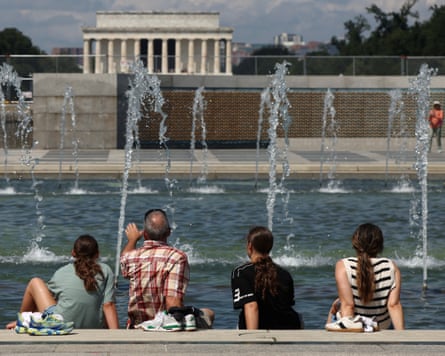 A family cools off in a fountain in Washington DC.
