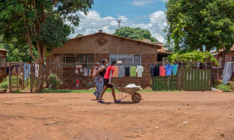 Women walk in the streets of Kuwadzana.