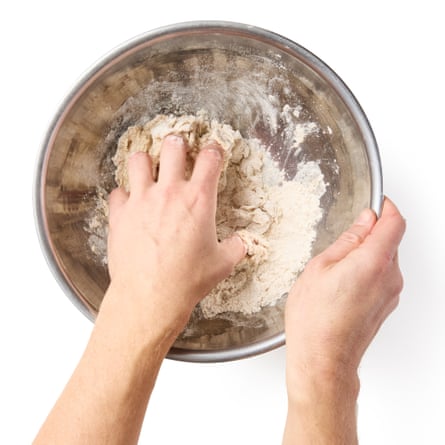 using your fingertips, gradually incorporate the liquids into the flour