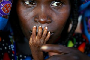 The fingers of malnourished one-year-old Alassa Galisou are pressed against the lips of his mother Fatou Ousseini at an emergency feeding clinic in the town of Tahoua in northwestern Niger, 1 August 2005. One of Niger’s worst droughts in living memory destroyed crops, leaving an estimated 3.6 million people short of food, including tens of thousands of starving children