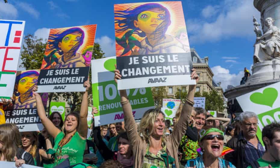 People hold placards at climate march in Paris, 2014
