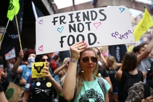 An animal rights protestor holds a placard during a march through central London as part of Extinction Rebellion’s August protests.
