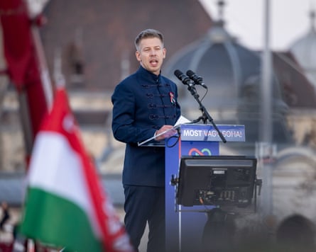 Péter Magyar standing at a podium speaking into a microphone