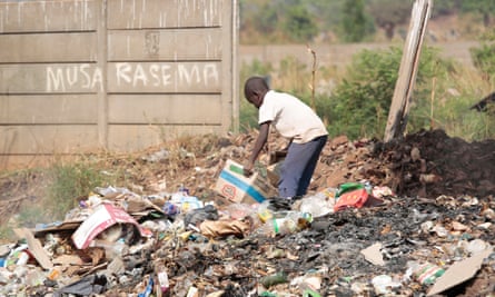 A child scavenges for plastic waste and cardboard for resale in the Harare township of Warren Park. Zimbabwe’s economic crisis means there is no treatment for most drug addicts.