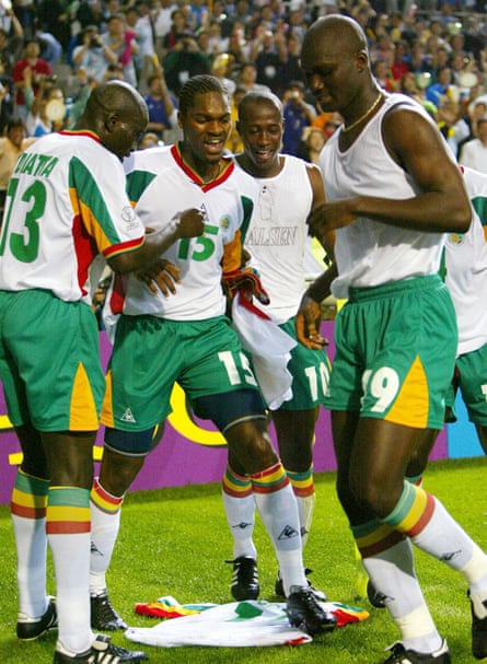 Senegal’s players dance around Papa Bouba Diop’s jersey after he scored