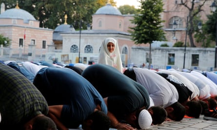 People pray outside the Hagia Sophia Grand Mosque in Istanbul.