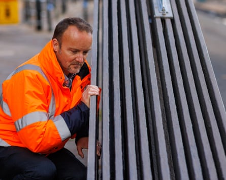 Tristan Ralph inspects the refurbished chain links of the bridge