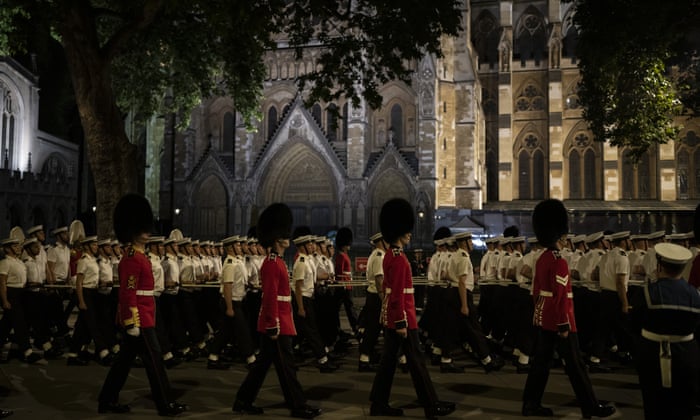 Guards and Royal Navy soldiers take part in a rehearsal for the funeral procession of Queen Elizabeth II in London. The Queen will lie in state in Westminster Hall for four full days before her funeral on Monday.