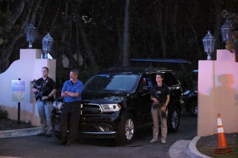 Armed secret service agents seen standing outside an entrance to the former president’s home late Monday.